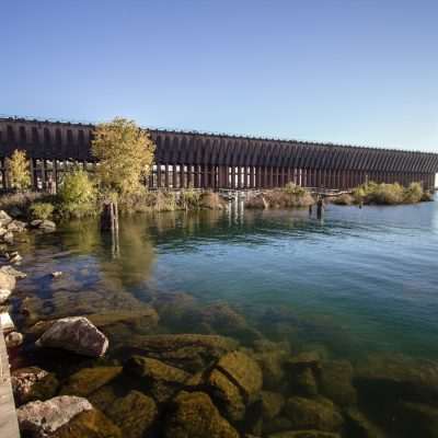 Historic ore dock by a calm lake.